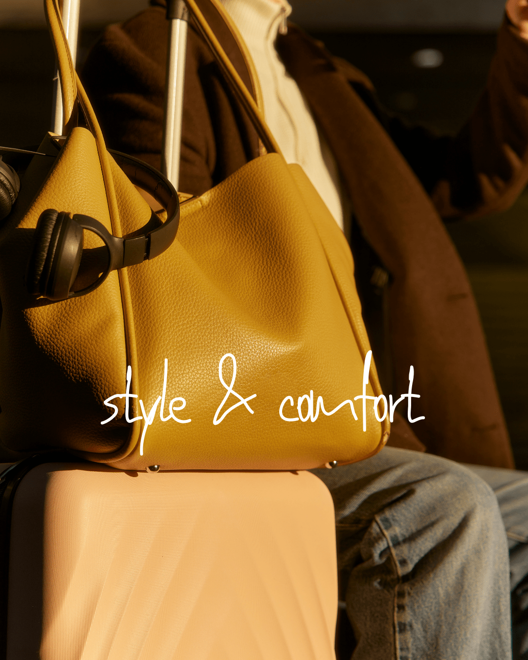 airport_outfits image featuring soft palette of yellow, blush accessories and brown coat with headphones for travel
