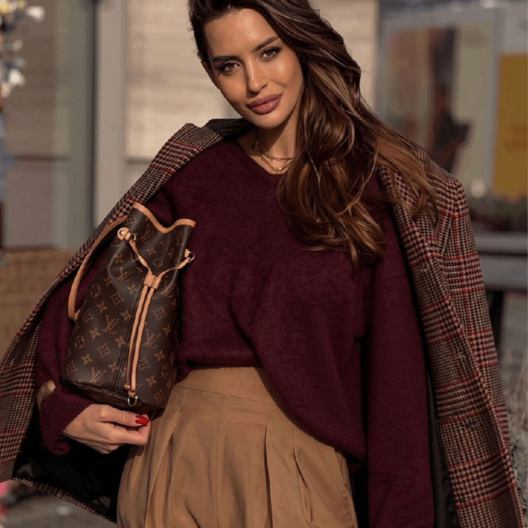 chocolate_and_cherry_outfir_inspiration_styleculture_4 lady with a Louis Vuitton never full bag standing with her chequered red stripe coat and cherry red sweater