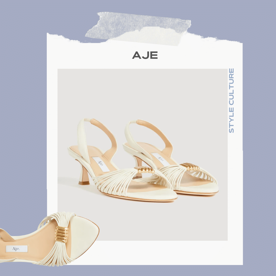 Aje ivory strappy low heel with statement gold hardware.